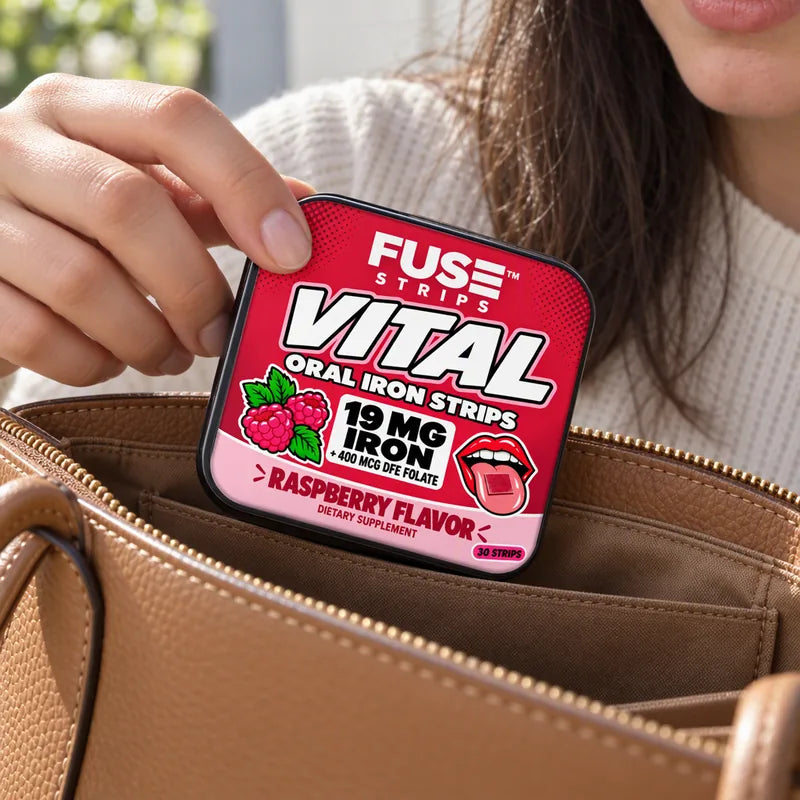 A hand tucking the Vital tin into a leather handbag